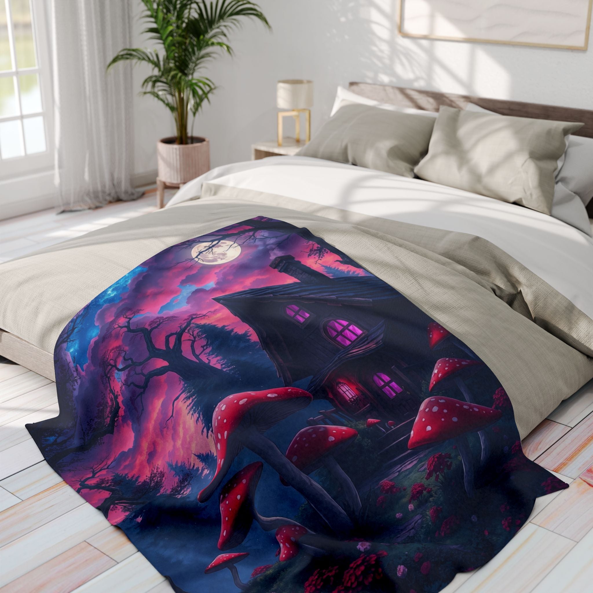 Decorative blanket with a fantasy halloween design of a haunted house with red and white mushrooms on a bed in a bright bedroom.