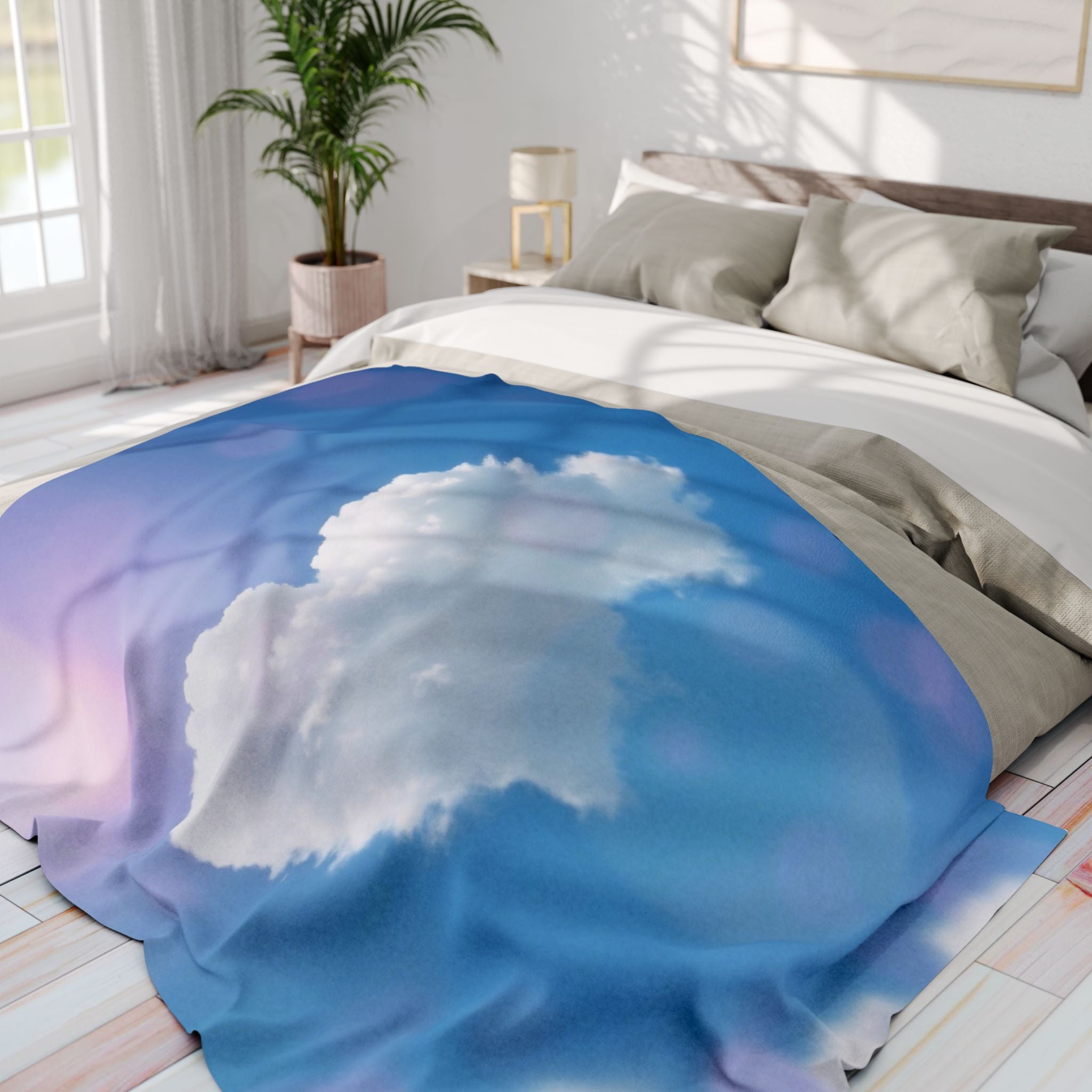 Bed with a white heart cloud fleece blanket in a blue sky in a bright bedroom.