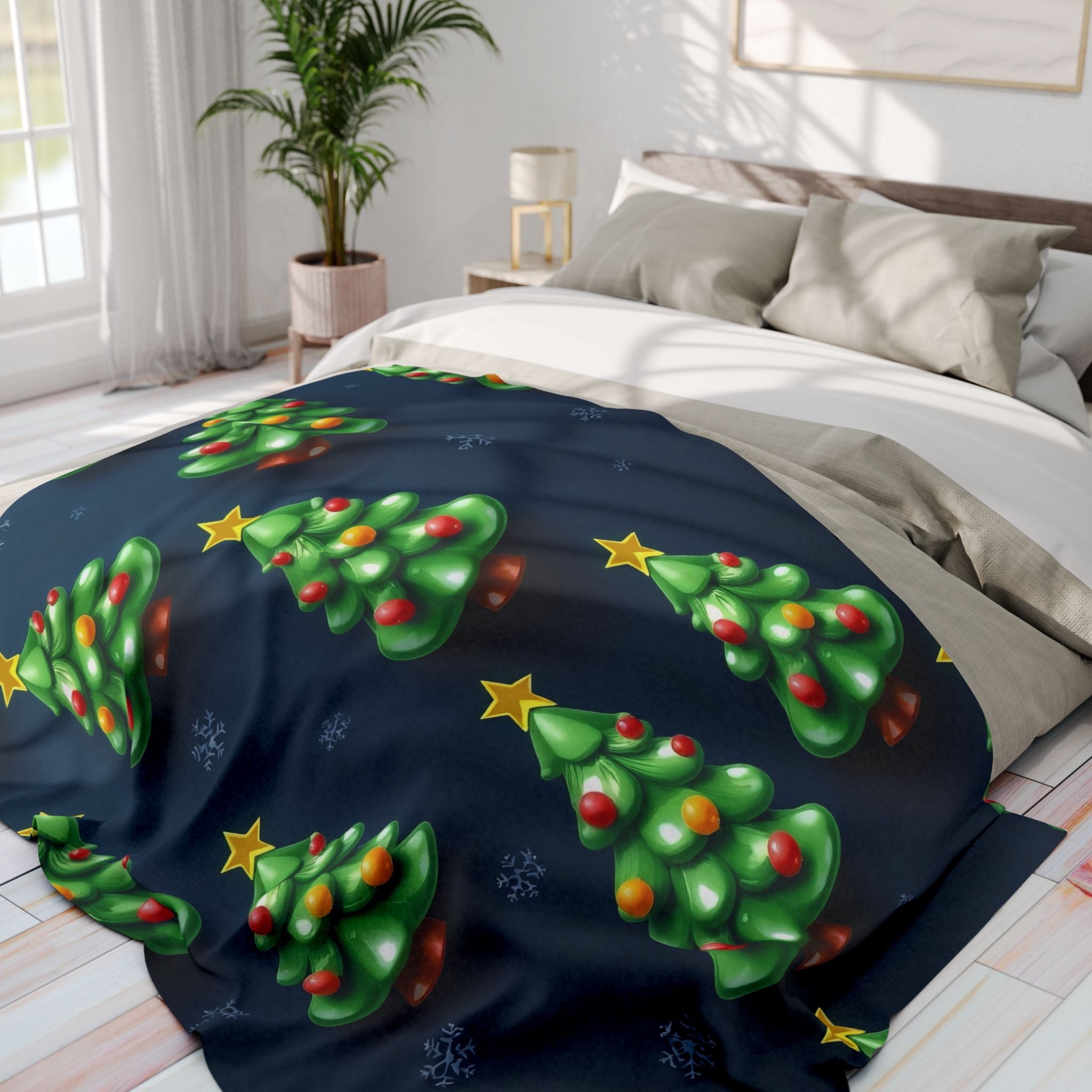 Blanket with Christmas tree design on a bed in a bedroom.