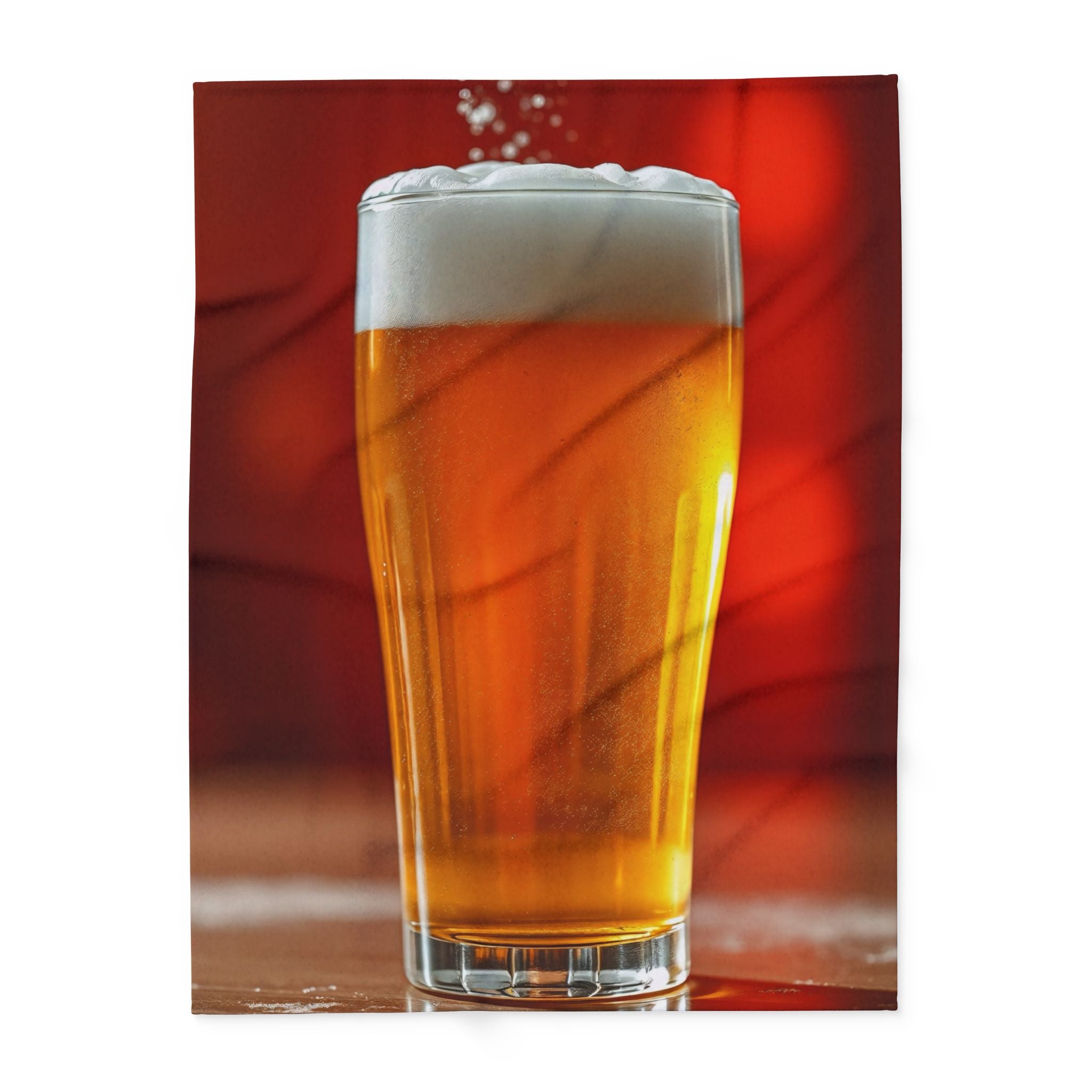 Fleece blanket of a pint of lager on a table with a red background.