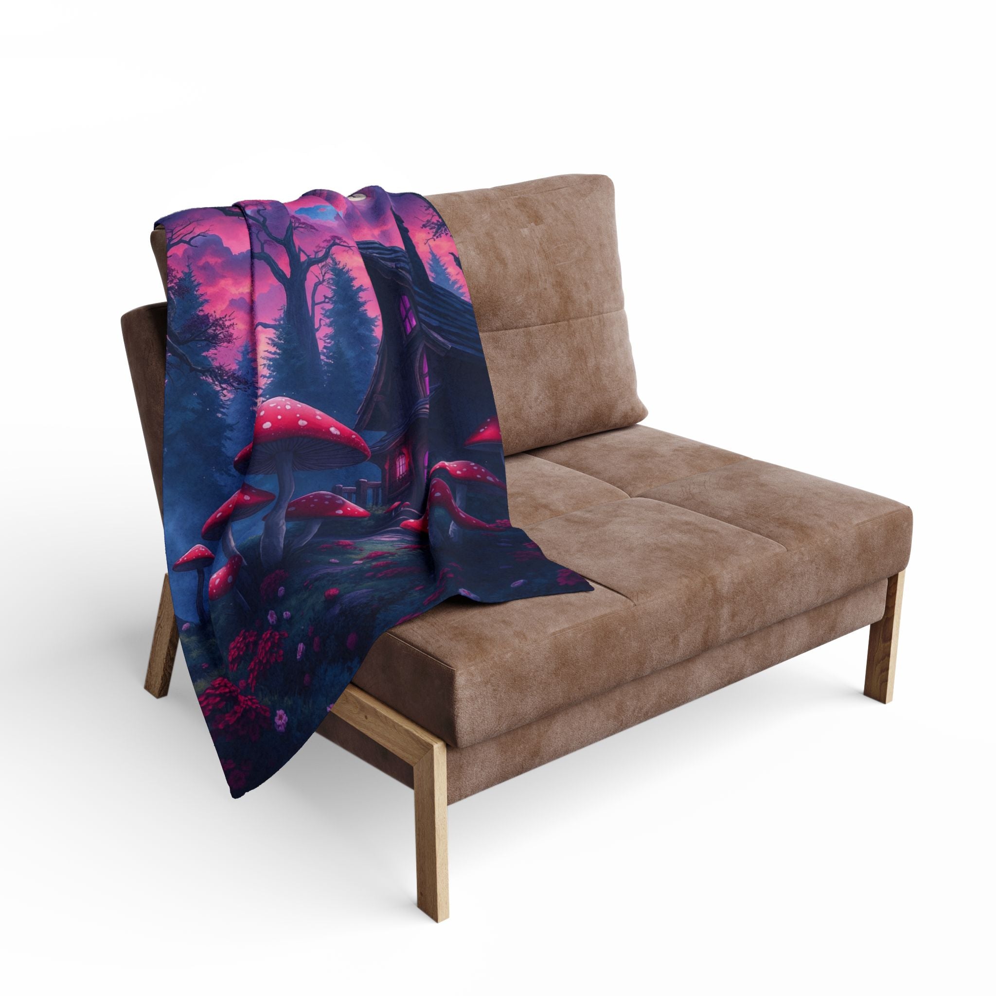 Brown sofa with a colorful fleece blanket featuring a halloween haunted cottage and toad stools draped over it on a white background.