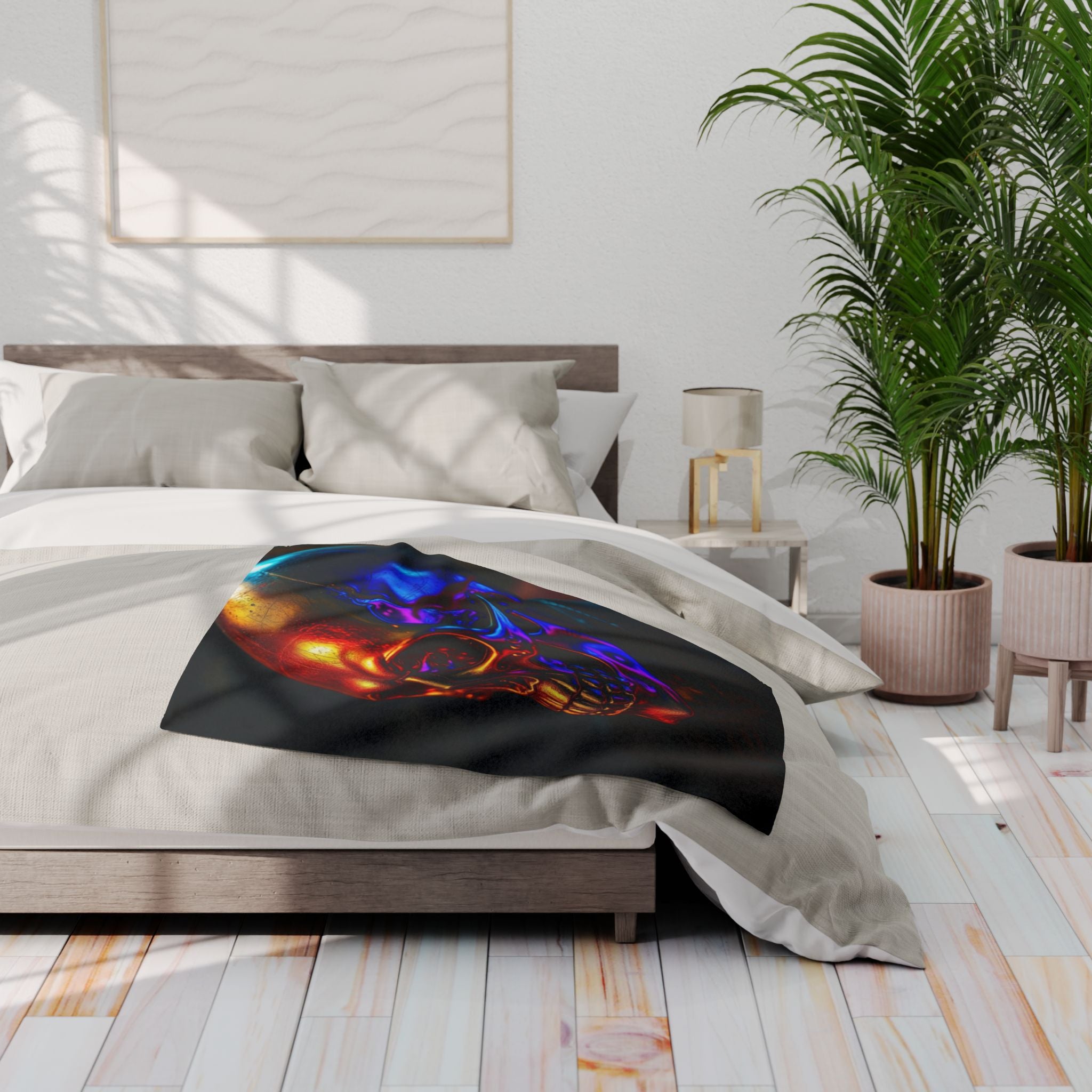 Bed with a black fleece blanket featuring a black golden skull design in a modern bedroom.