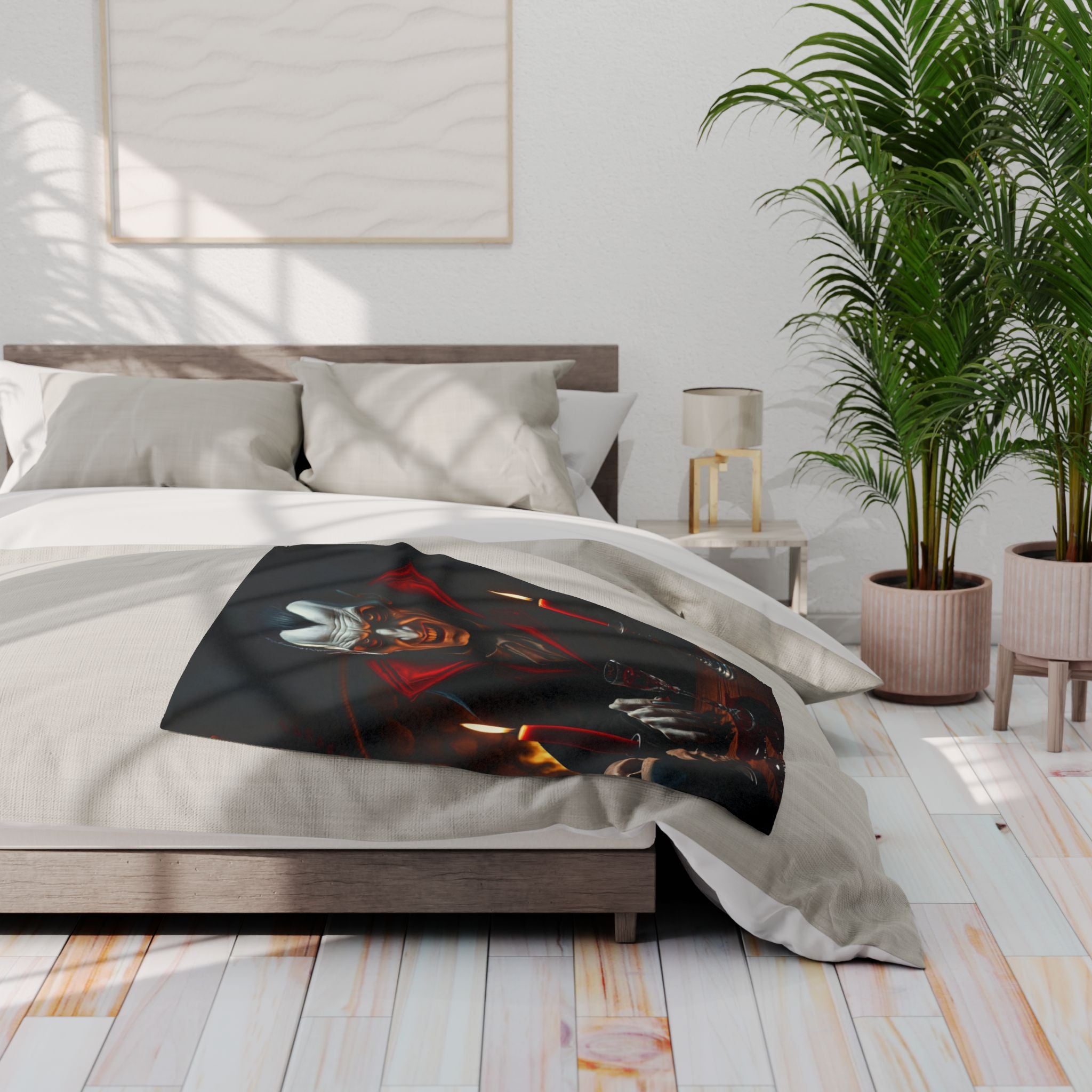 Bedroom with a bed featuring a halloween themed count dracula fleece blanket, nightstand with a lamp, and two potted plants.