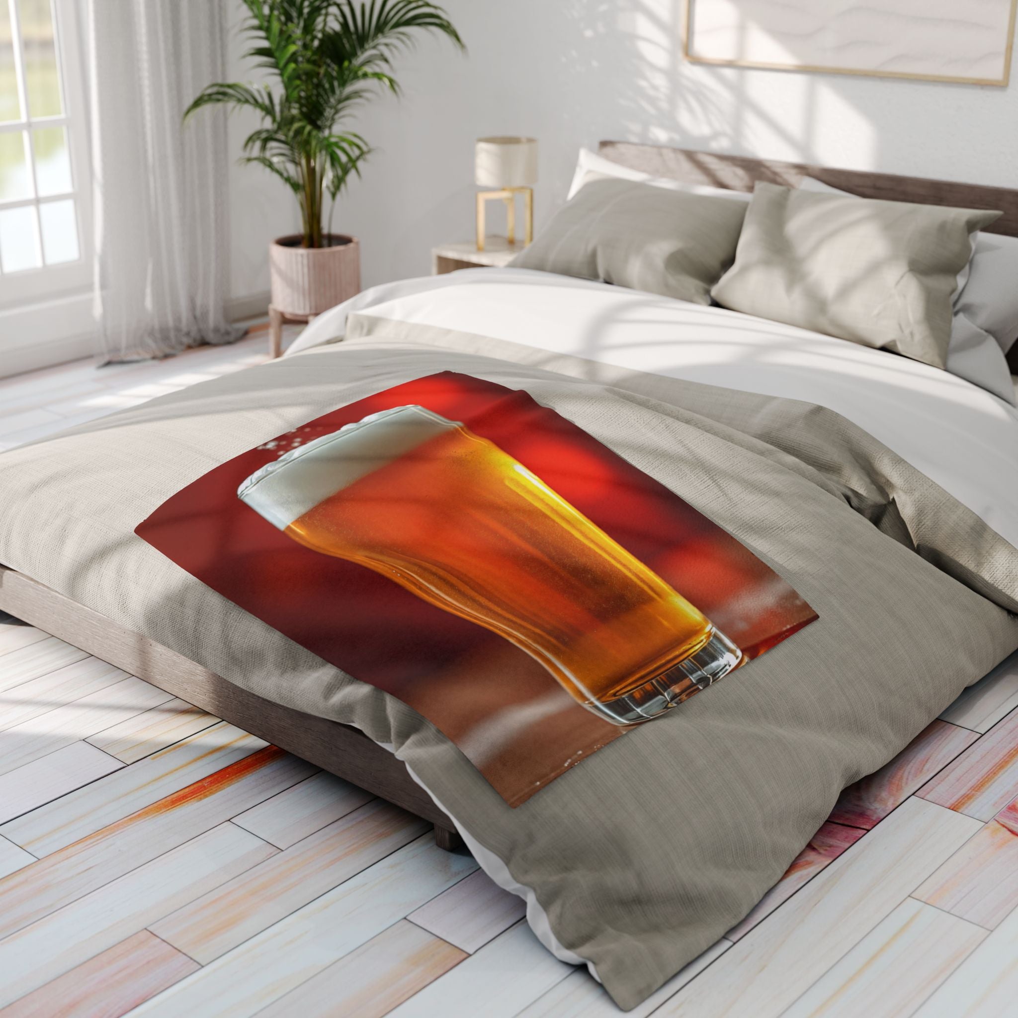 Bedding set with a fleece blanket of a glass of beer design on a bed in a bright bedroom.