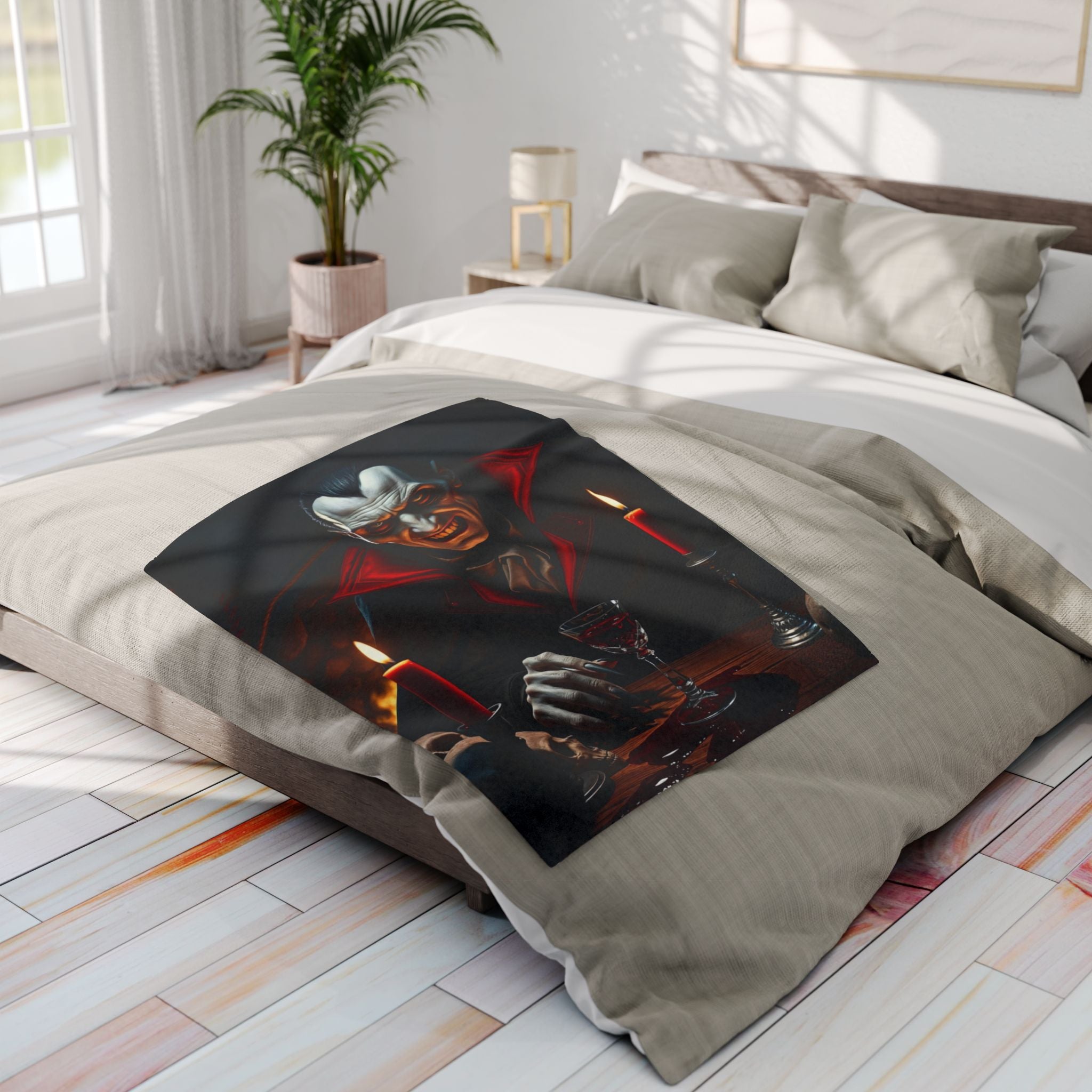 Fleece blanket featuring a halloween themed count dracula design on a bed in a bright bedroom.