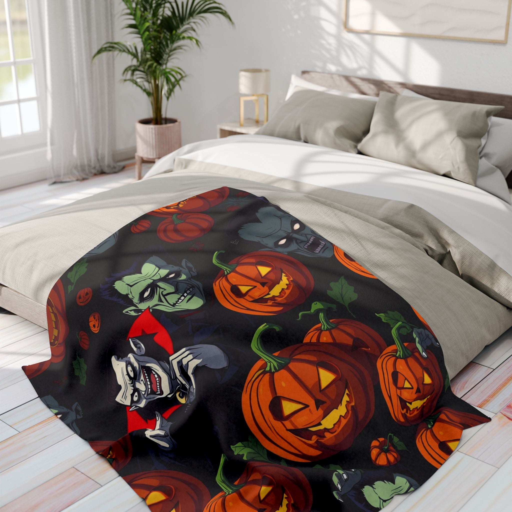 Halloween themed fleece blanket featuring Dracula, Frankenstein and pumpkin lanterns draped over a bed in a bright bedroom.