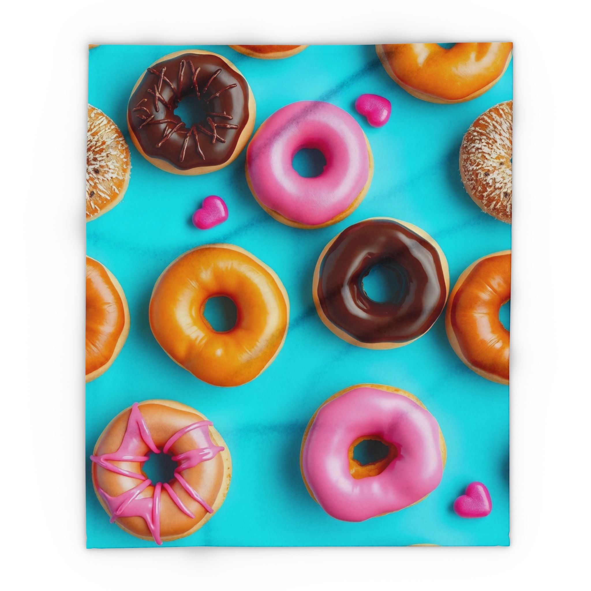 Warm fleece blanket of pink and chocolate donuts with different glazes on a blue background.